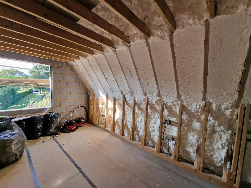 Corrugated roof spray foam insulation