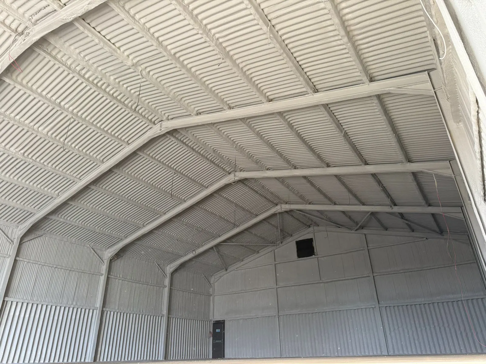 Spray foam insulation applied to hangars — real Duratite Group project