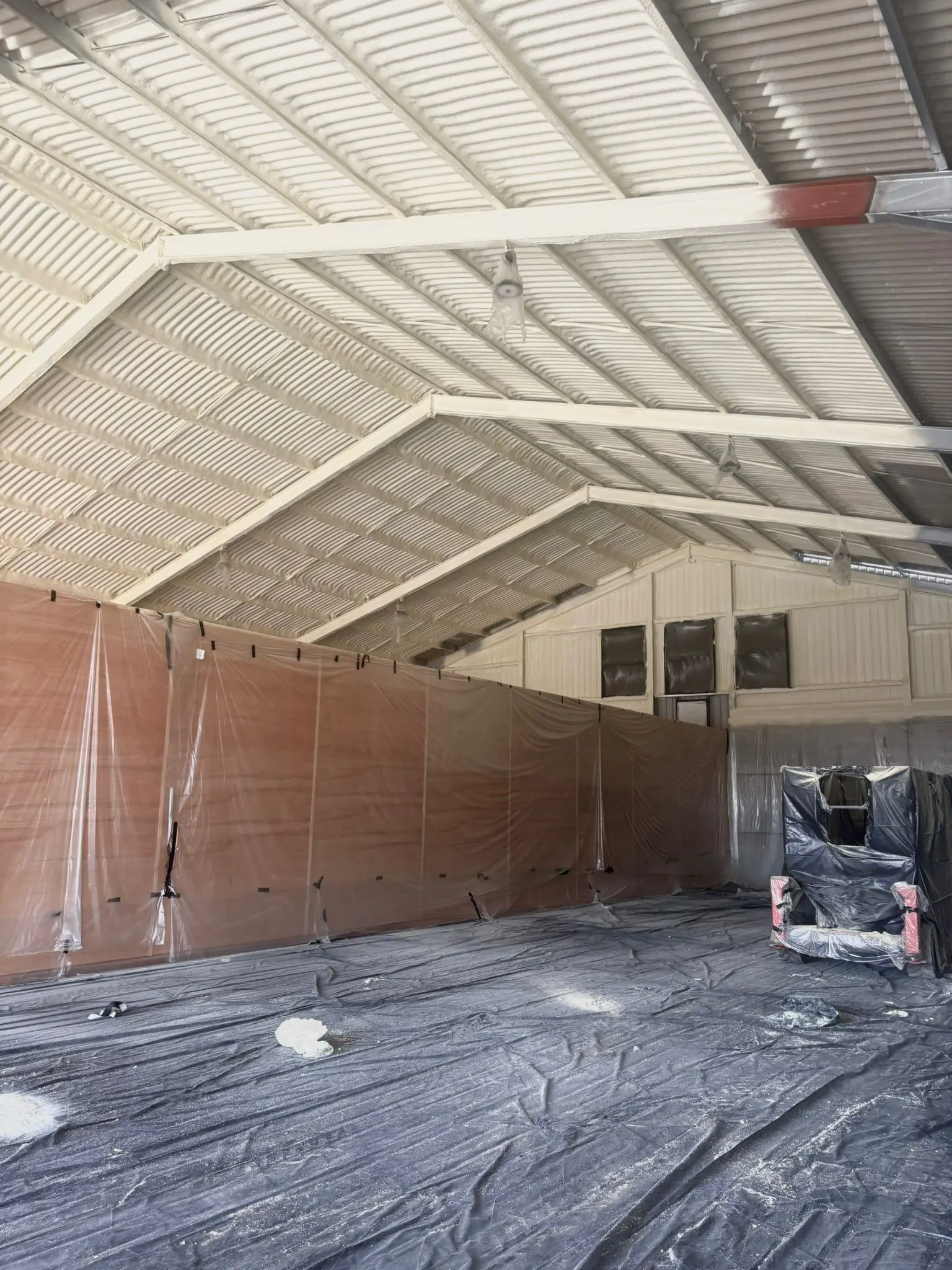 Spray foam insulation applied to asbestos roofs — real Duratite Group project