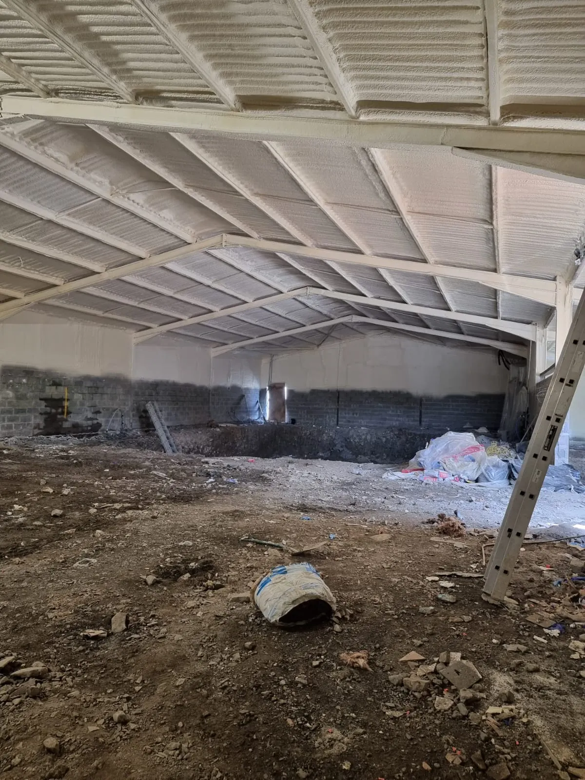 Spray foam insulation applied to asbestos roofs — real Duratite Group project