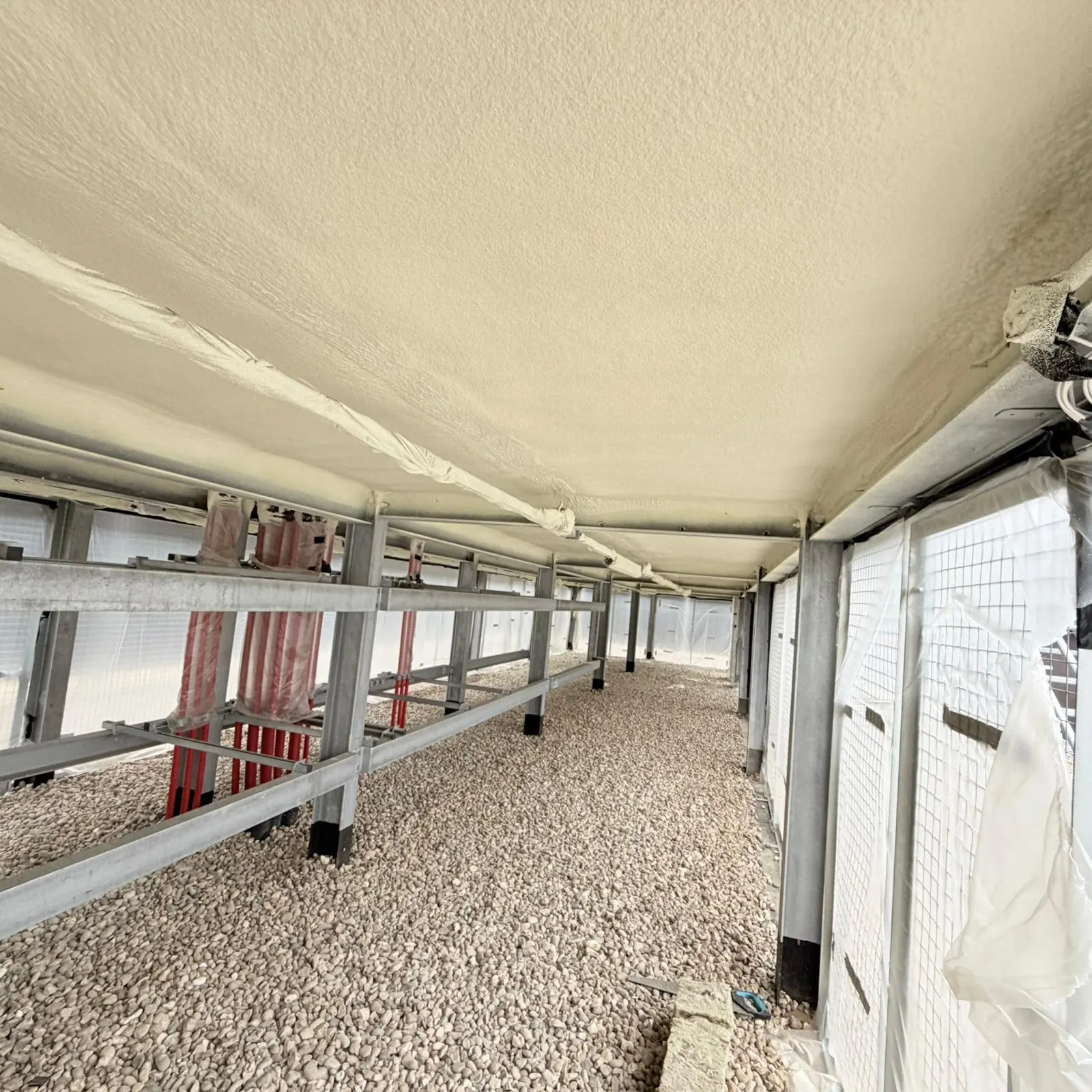 Spray foam insulation applied to ceiling voids — real Duratite Group project
